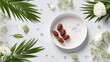 © Pacul - Ripe pitted fruits rest on a white dish surrounded by green foliage and delicate white blossoms