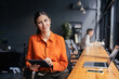 © Stock 4 You - Executive CEO businesswoman professional holding digital tablet pc device for work in office, looking at camera. Successful latin hispanic young woman using pad computer for business app. Copy space