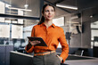 © Stock 4 You - European young businesswoman CEO holding digital tablet using fintech tab, looking dreaming at copy space at workplace in office. Latin Hispanic professional business woman looking at online trade app