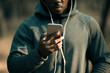 © Davor - Man using smartphone with earphones during outdoor workout