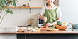 © buritora - Middle-aged Asian woman cooking in the kitchen (cutting, knife, cooking, home-cooked meal)