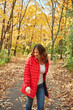 © peopleimages.com - Woman, smile and walking in forest with autumn leaves, wellness and outdoor adventure on weekend break. Happy, female person and stroll in countryside with fall foliage, nature exploration and peace.
