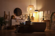 © Pixel-Shot - Interior of bathroom with glowing lamps, bench and sink in evening