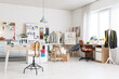 © Pixel-Shot - Interior of light fashion designer's studio with tables, clothes rack and mannequin
