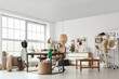 © Pixel-Shot - Interior of fashion designer's studio with workplace, mannequins and clothes rack
