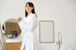 © Pixel-Shot - Young woman in soft bathrobe at home
