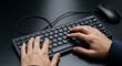 © Tiyur - Person's hands actively typing on a compact electronic keyboard with an adjacent pointing device