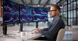 © Andrey Popov - Young Professional Monitoring Financial Markets On Multiple Screens