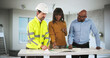 © Andrey Popov - Young Engineer And Contractor Discussing House Plans With Couple