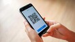 © Lens Alchemy - Person Scanning QR Code on Smartphone for Mobile Payment or Information