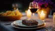 © GATE 22 - Table setting with a plate of food and a glass of red wine. the plate is white with a gold rim and has a piece of steak on it.