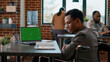 © DC Studio - Company employee analyzing greenscreen on laptop, working in disability friendly office. Businessman using chromakey background with isolated copyspace and blank mockup template.