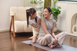 © Blue Jean Images - A mum and her daughter find happiness practicing yoga together at home