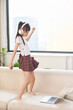 © Blue Jean Images - A little girl dances to the music