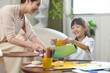 © Blue Jean Images - Mum helping girl doing her art homework