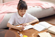 © Blue Jean Images - A girl doing her homework at her desk