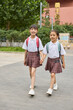 © Blue Jean Images - Two happy girls after school