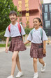 © Blue Jean Images - Two happy girls after school