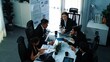 © InfiniteFlow - Top view of female leader looking financial statistic at business meeting. Professional marketing team looking and analyzing stock market investment graph and planning strategy. Teamwork. Directorate.