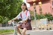 © Blue Jean Images - A girl riding a bike after school