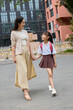 © Blue Jean Images - Mum picking up her daughter from school
