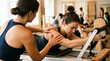 © Valentina Sorokina - Instructor assisting woman during Pilates reformer exercise in modern studio setting. Personal training concept representing guidance, correction, support and proper technique.