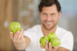 © auremar - handsome man holding green apples
