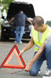 © auremar - close up of a man putting road triangle