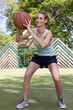 © auremar - adult woman playing basketball outdoors