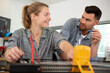 © auremar - mentor and tradeswoman using a multimeter