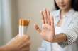 © Pormezz - person showing hand sign to rejection cigarette for quit smoke motivation.