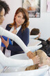 © auremar - teacher observing hairdressing apprentice while washing clients hair