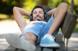 © auremar - man relaxing on park bench on a summers day