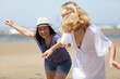 © auremar - a couple of young women enjoying the sea side