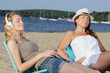 © auremar - two female friends relaxing on the beach