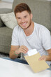 © auremar - smiling male entrepreneur holding a letter