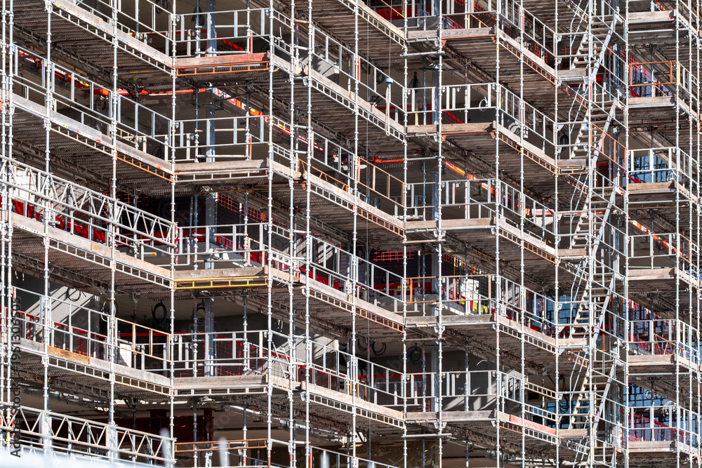 Urban construction scaffolding framework with metal platforms and ...