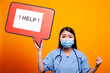 © DC Studio - Asian woman doctor with her fist raised, asking for help using a cardboard speech bubble. Female nurse wearing scrubs and face mask, holding a red signboard against an isolated background.