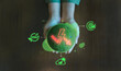 © HappyEva - green earth globe glowing climate change energy depletion warning icons, emphasizing global responsibility and ESG commitment, Protecting nature future environment ESG, Overheard view of cupped hands