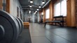 © Bussakon - Foreground focus on weight plates in a modern gym blurred equipment in background