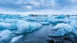© Anna - Floating Icebergs in a glacial river under dramatic clouds