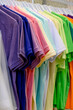 © bo.kvk - Colorful assortment of folded cotton t-shirts displayed on hangers