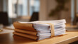 © Tania - A neatly tied stack of documents features an elastic band binding them, pointing to the significance of organization in professional settings and simplifying the management of paperwork. cinematic