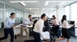 © 24DIY - Several diverse business professionals rush through a contemporary open plan office carrying various work items with