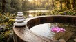 © KAMRUL41 - Serene outdoor wooden hot tub with stacked stones and pink flower in forest near lake at sunset