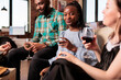 © DC Studio - Horizontal shot of smiling, happy, glad young adult african american girl enjoying social life, wine glass at friends, mates, partners apartment, home, house made party, reunion, gathering.