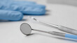 © A2Z AI  - Essential dental examination tools and protective gloves on a clean white surface, symbolizing oral health, hygiene, and professional care