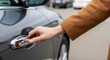 © Eve - Close up of hand opening silver car door in daylight, woman in brown coat touching chrome vehicle handle, elegant lifestyle and automotive concept, female driver entering luxury automobile.