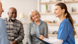 © Prostock-studio - A healthcare professional is talking to three patients in a consultation room. The patients look focused and engaged. The setting appears bright and welcoming.