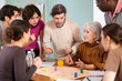 © JackF - Group of people of different ages is actively playing a board game, discussing and conducting a discussion in the interior of the office